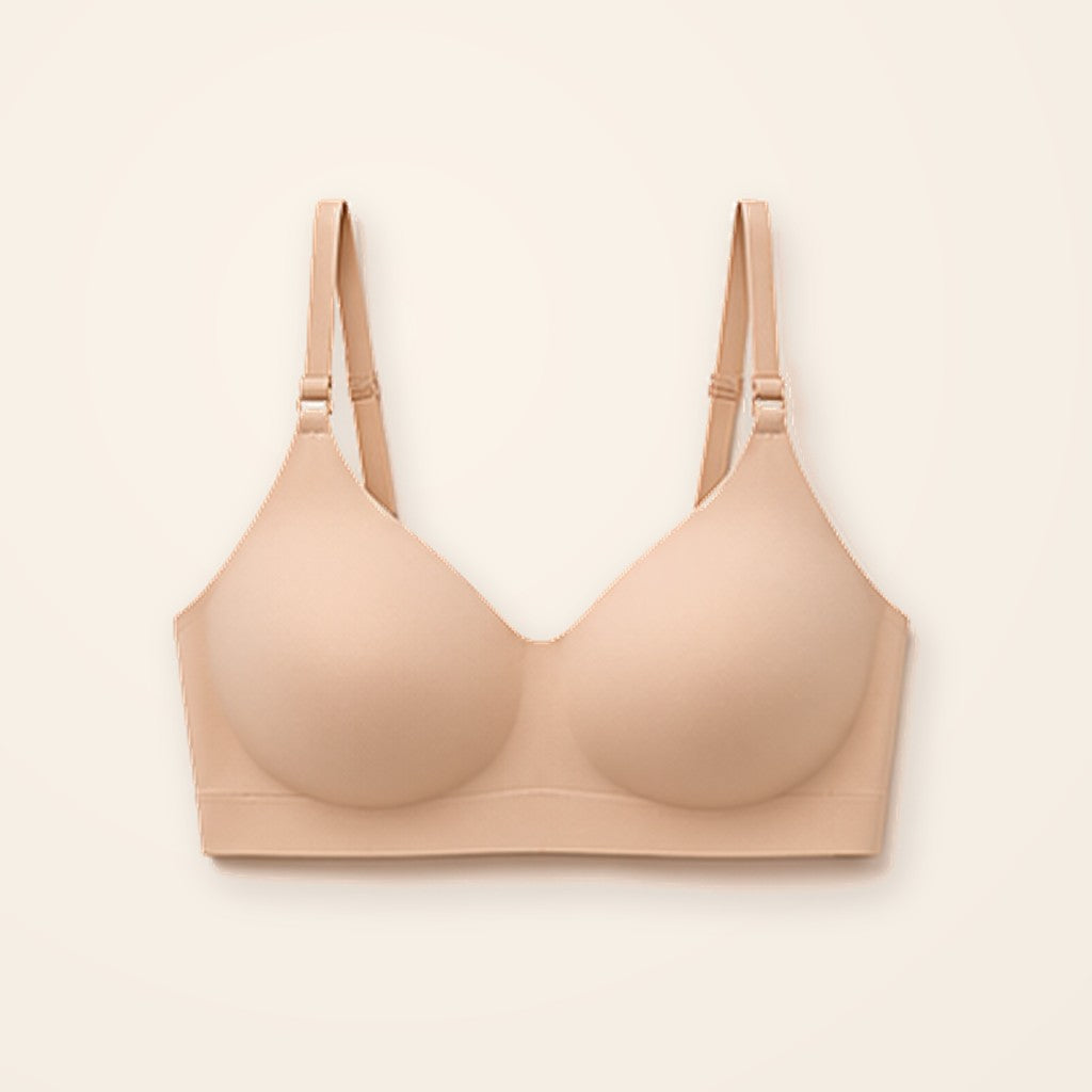 Sostén camiseta nude sin costuras con tirantes ajustables, sobre fondo crema