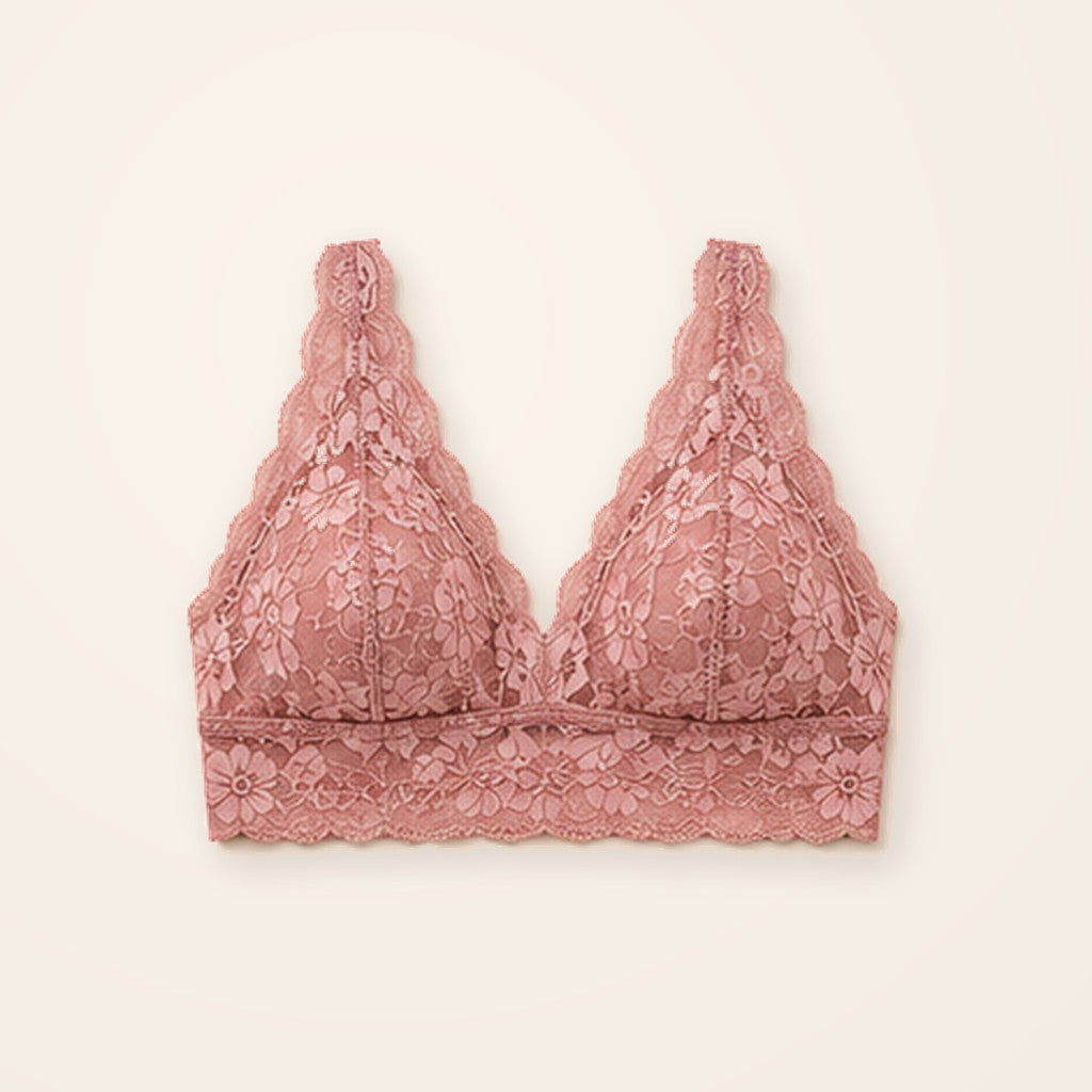 Bralette de encaje rosa con banda ancha y suave, sobre fondo crema