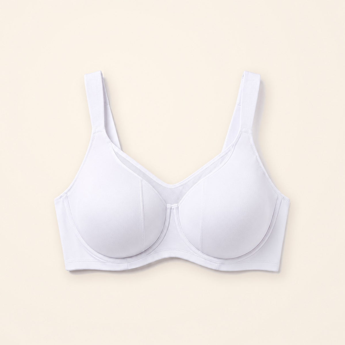 Sostén minimizer blanco con panel de malla, sobre fondo crema
