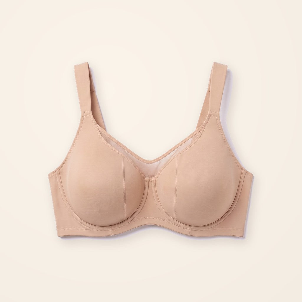 Sostén minimizer beige con panel de malla, sobre fondo crema