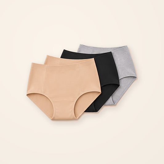 Paquete de 3 panties sin costuras de tiro alto en nude, negro y gris, sobre fondo crema